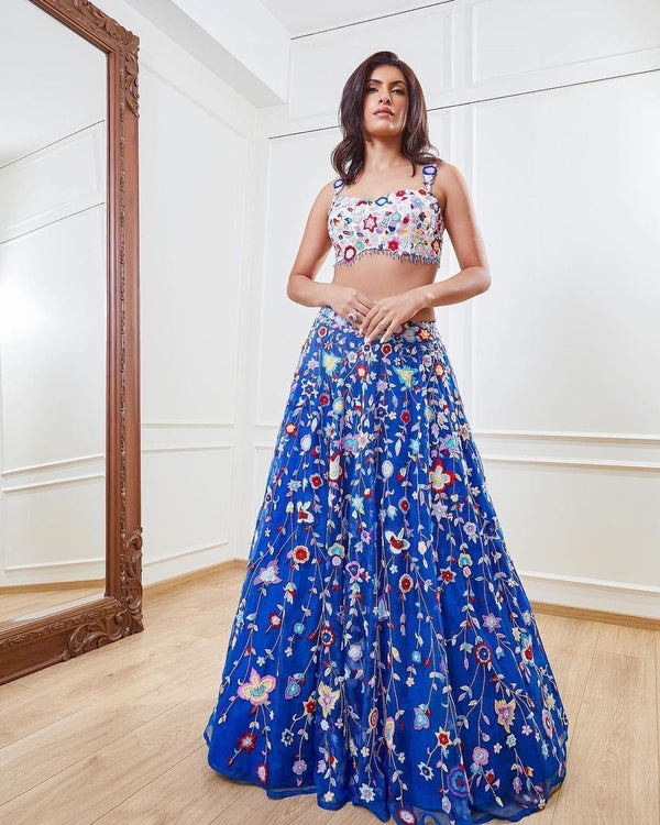 Demanding Net Embellished Blue Color Lehenga Choli